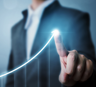 man in a suit drawing a curve showing increasing profits over time
